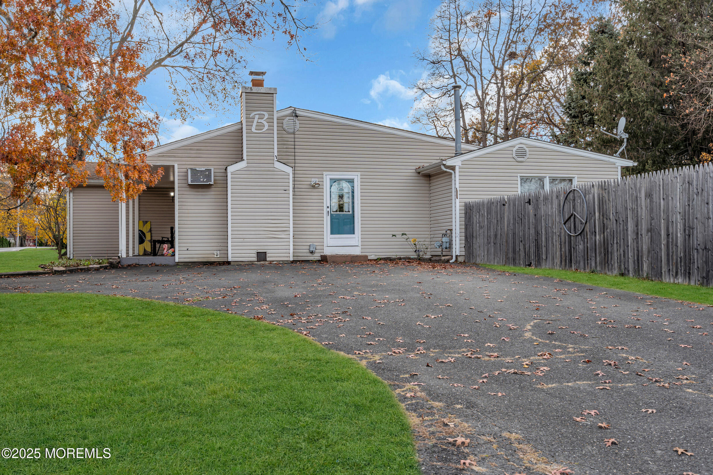 1541 Commonwealth Boulevard Toms River, NJ 08757 - Photo 32 of 34 a view of a grey house with backyard and trees