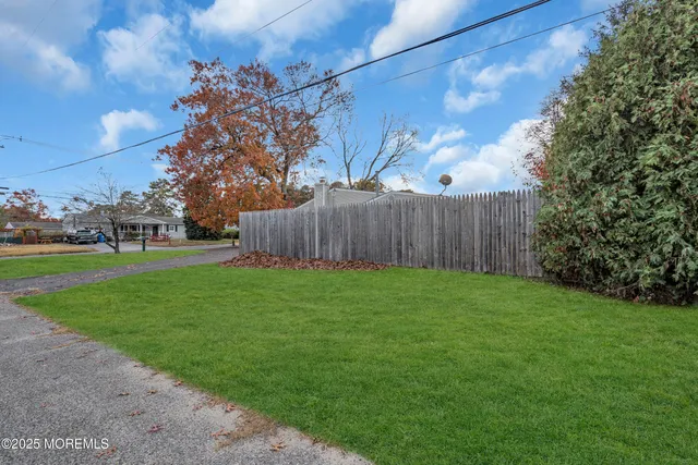 a view of a backyard with large trees