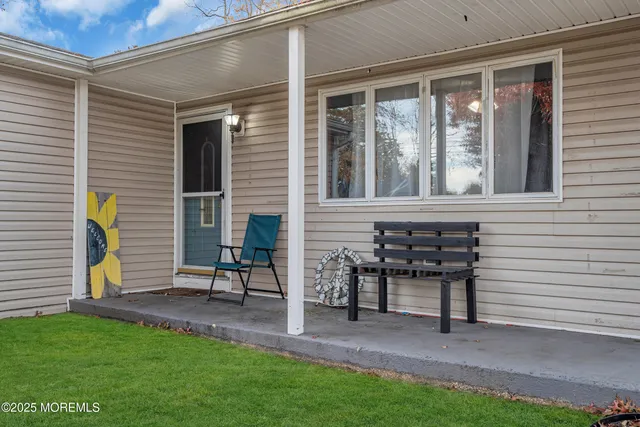a view of an house with backyard porch and sitting area