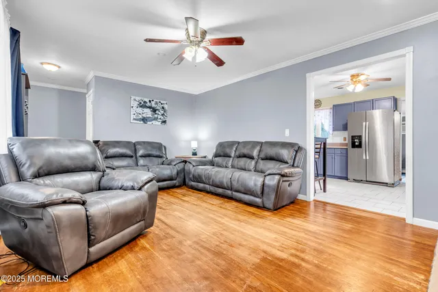 a living room with furniture and a chandelier