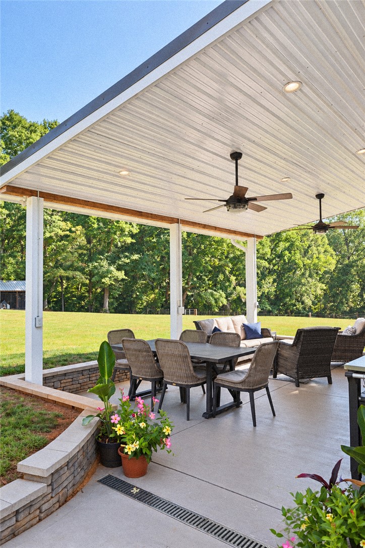 2420 Rainey Road Starr, SC 29684 - Photo 27 of 36 An inviting covered patio features a concrete floor and overlooks a lush green yard.