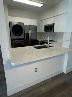 a kitchen with a microwave and a refrigerator