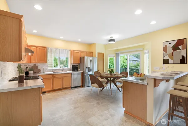 a kitchen with stainless steel appliances kitchen island granite countertop a sink and cabinets