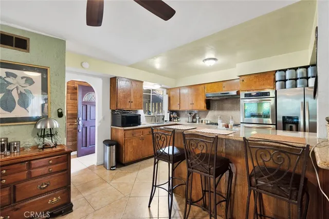 a kitchen with stainless steel appliances granite countertop a stove and a refrigerator