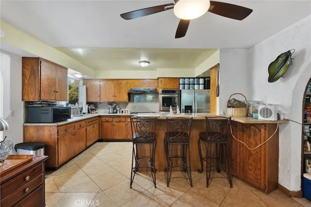 a kitchen with a sink counter and chairs