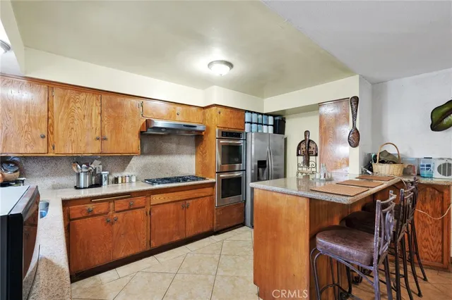 a kitchen with stainless steel appliances granite countertop a sink counter space and cabinets