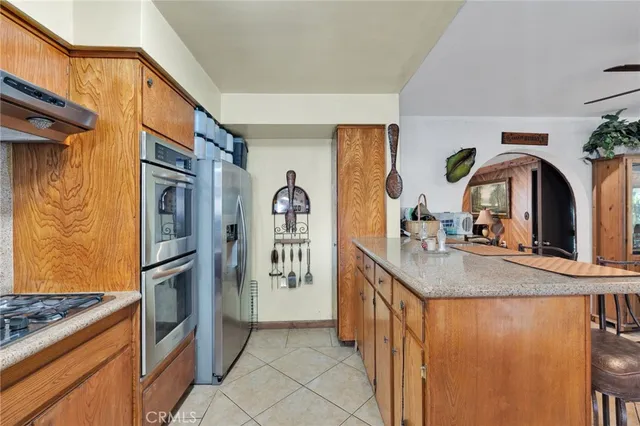 a kitchen with stainless steel appliances granite countertop a refrigerator and a stove