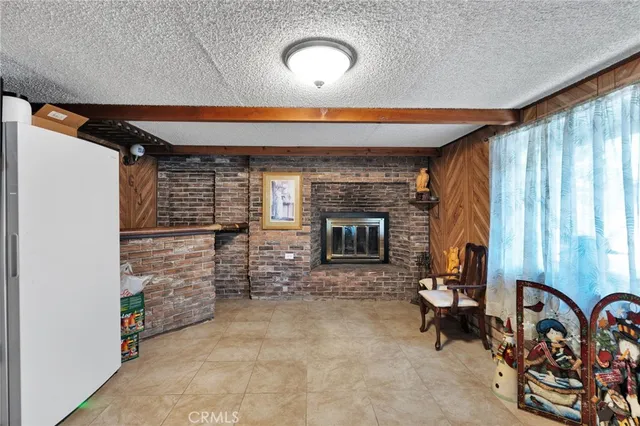 a living room with furniture a fireplace and a window