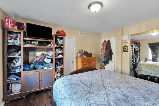 a bed room with a bed and a television