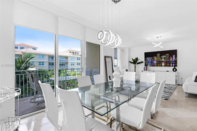 a view of a dining room with furniture wooden floor and chandelier