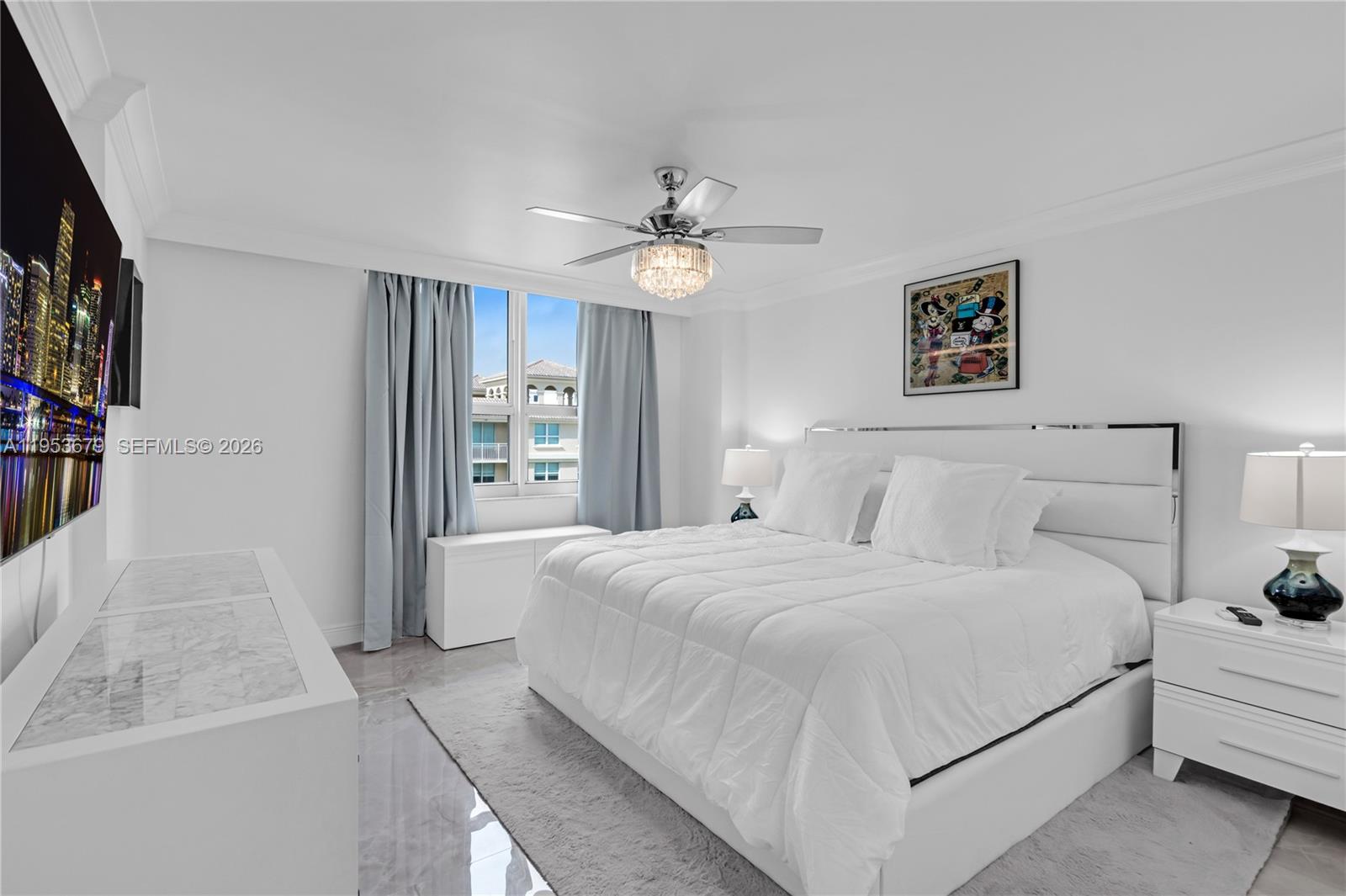 99 Southeast Mizner Boulevard, Unit PH16 Boca Raton, FL 33432 - Photo 11 of 30 a bedroom with a large bed and a chandelier