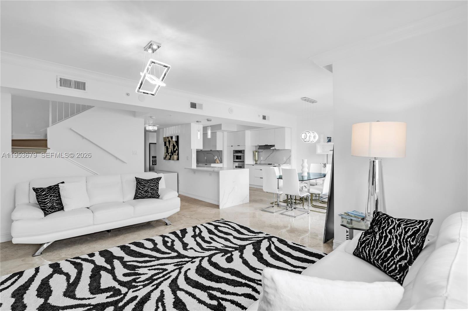 99 Southeast Mizner Boulevard, Unit PH16 Boca Raton, FL 33432 - Photo 2 of 30 a living room with furniture