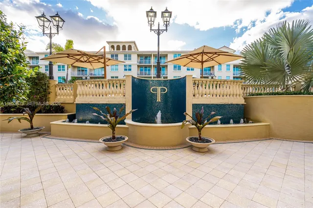 a front view of a building with glass door and seating space