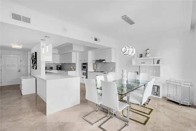 a living room with furniture a clock and cabinets