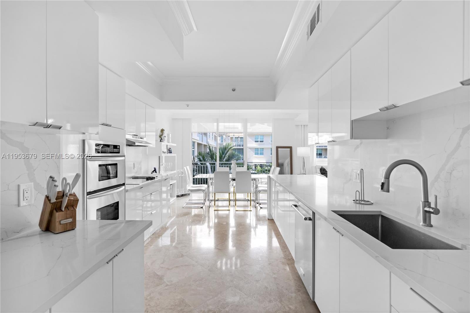 99 Southeast Mizner Boulevard, Unit PH16 Boca Raton, FL 33432 - Photo 5 of 30 a large kitchen with a lot of counter space