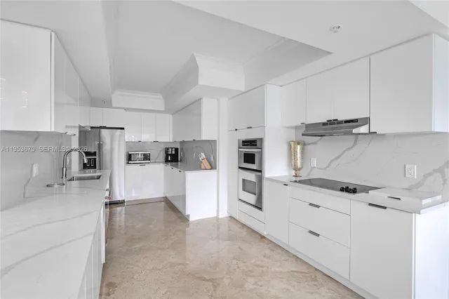 a kitchen with white cabinets and white appliances