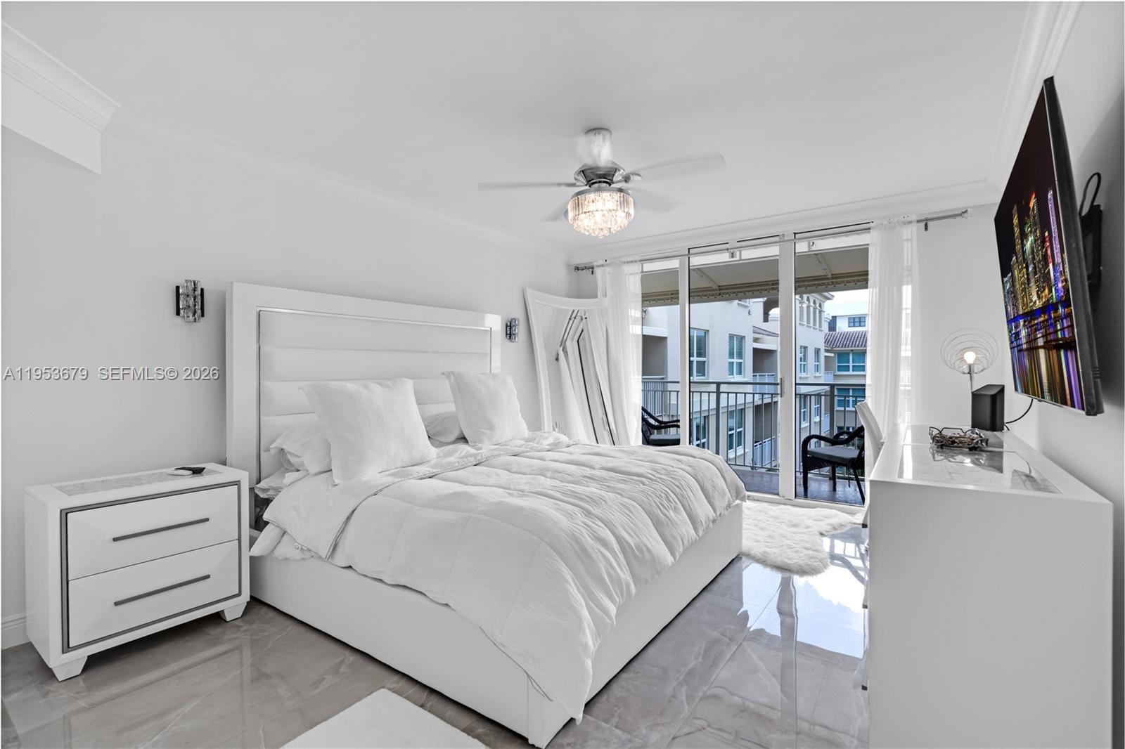 99 Southeast Mizner Boulevard, Unit PH16 Boca Raton, FL 33432 - Photo 9 of 30 a bedroom with a bed and a flat screen tv