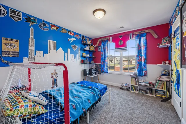 a bedroom with furniture and a large window