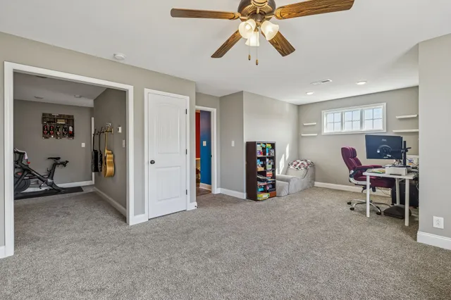 a view of a livingroom with a furniture and a ceiling fan