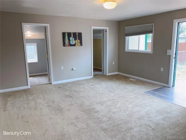 an empty room with windows and closet