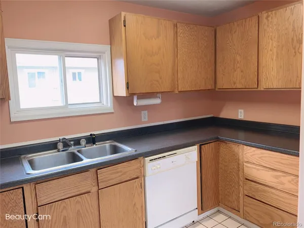 a kitchen with a sink cabinets and a window