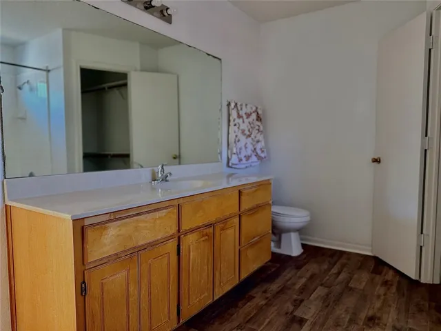 a bathroom with a sink a toilet and mirror