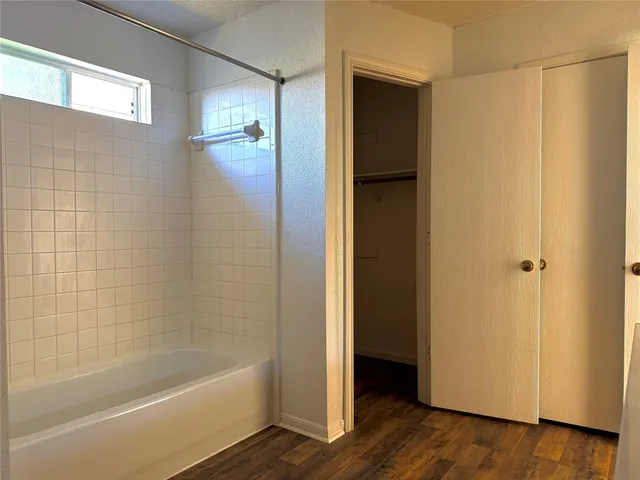 a bathroom with a bathtub and a shower