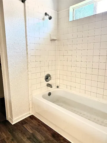 a bathroom with a bathtub and shower