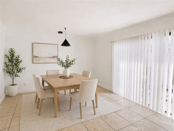 a dining room with furniture and potted plants