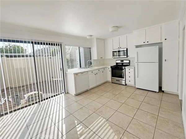 a kitchen with a cabinets a sink and stainless steel appliances