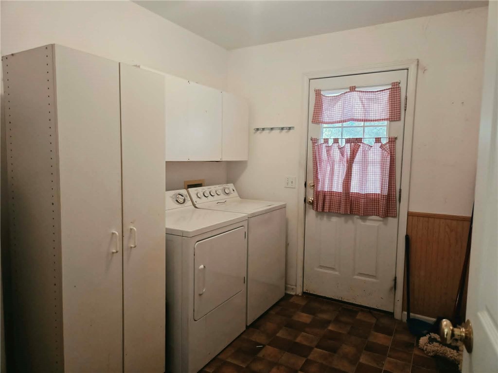 202 Keith Lane Seneca, SC 29678 - Photo 17 of 23 Functional laundry space featuring convenient storage cabinetry and a classic washer and dryer set.