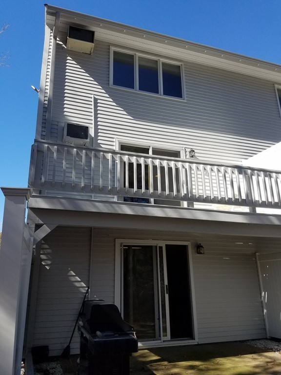 174 Lowell Road, Unit 82 Mashpee, MA 02649 - Photo 11 of 16 a front view of a house with balcony