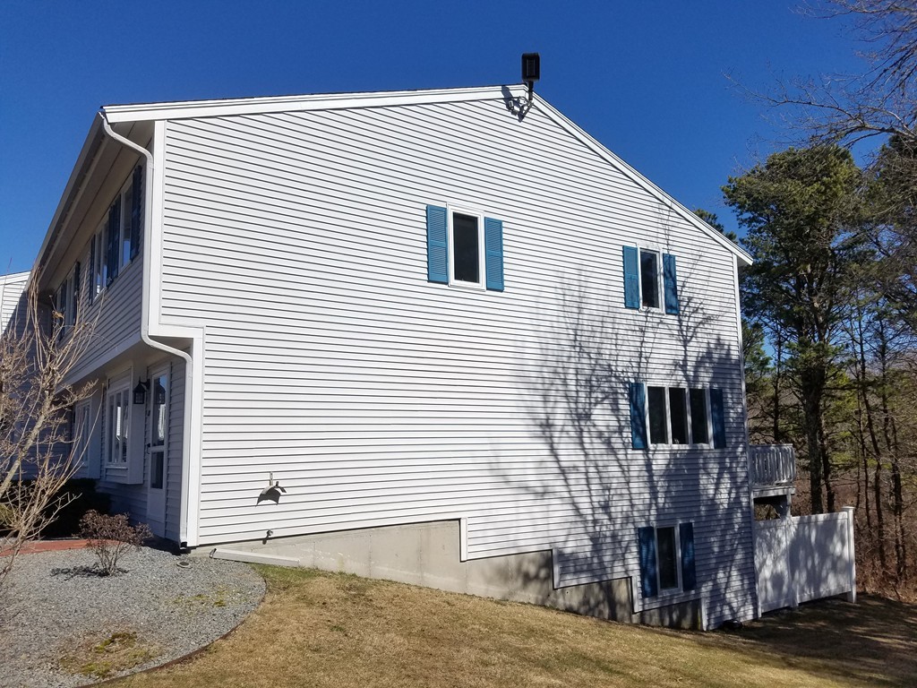 174 Lowell Road, Unit 82 Mashpee, MA 02649 - Photo 12 of 16 a view of a house with a street