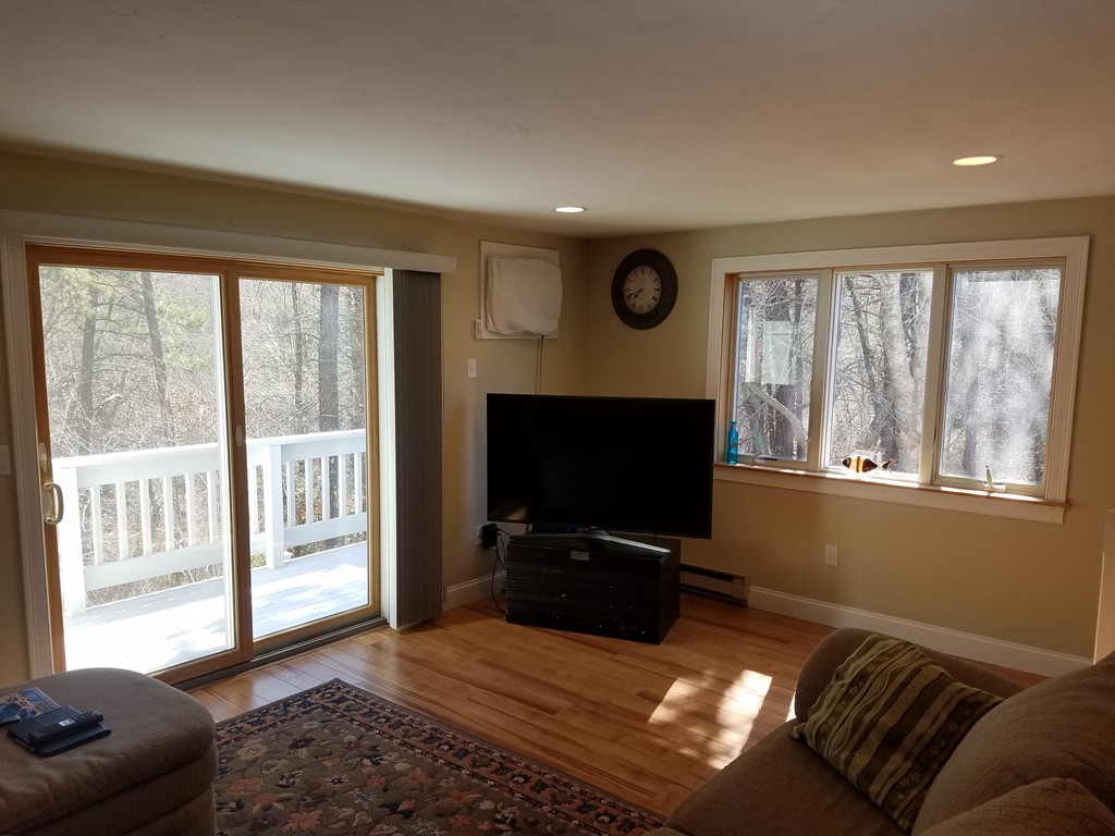 174 Lowell Road, Unit 82 Mashpee, MA 02649 - Photo 4 of 16 a living room with furniture and a flat screen tv