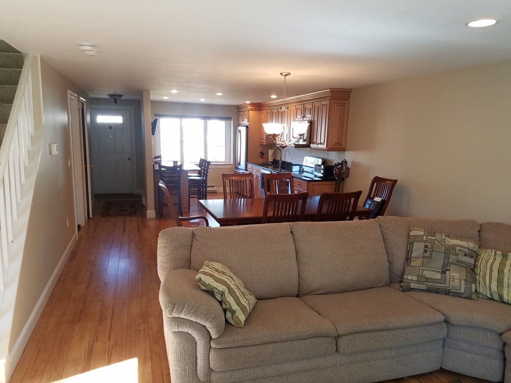 174 Lowell Road, Unit 82 Mashpee, MA 02649 - Photo 5 of 16 a living room with furniture and wooden floor