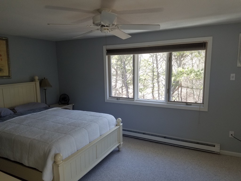 174 Lowell Road, Unit 82 Mashpee, MA 02649 - Photo 6 of 16 a bedroom with a bed and a window