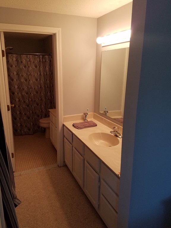 174 Lowell Road, Unit 82 Mashpee, MA 02649 - Photo 7 of 16 a bathroom with a double vanity sink and a mirror