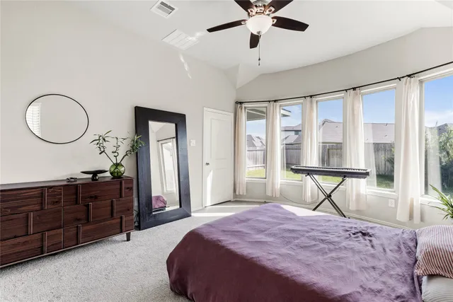 a bedroom with a large bed and a chandelier