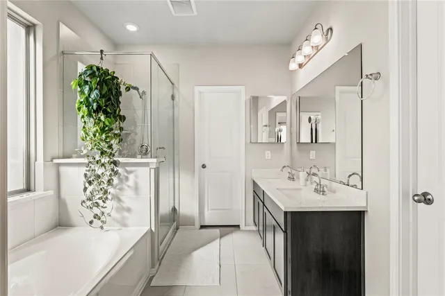 a en suite bathroom with a granite countertop sink and a mirror