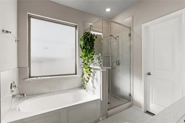 a bathroom with a tub shower and a sink