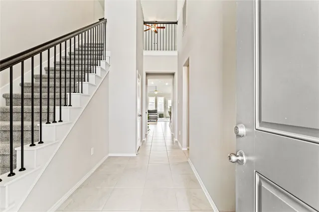a view of a hallway with wooden floor and staircase