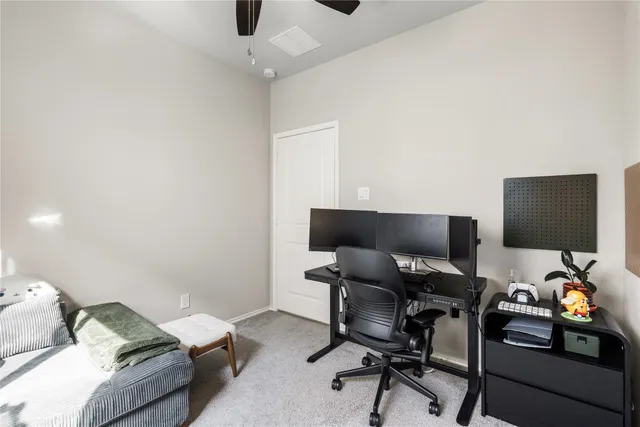 a work room with furniture and a ceiling fan