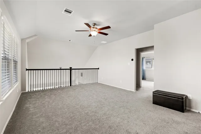 a view of a livingroom with a ceiling fan and window