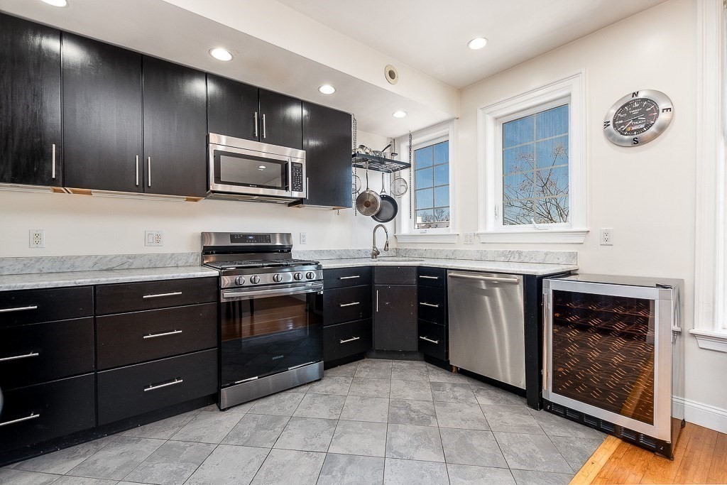 151 G Street, Unit 3 Boston, MA 02127 - Photo 15 of 33 a kitchen with stainless steel appliances granite countertop a stove and a sink
