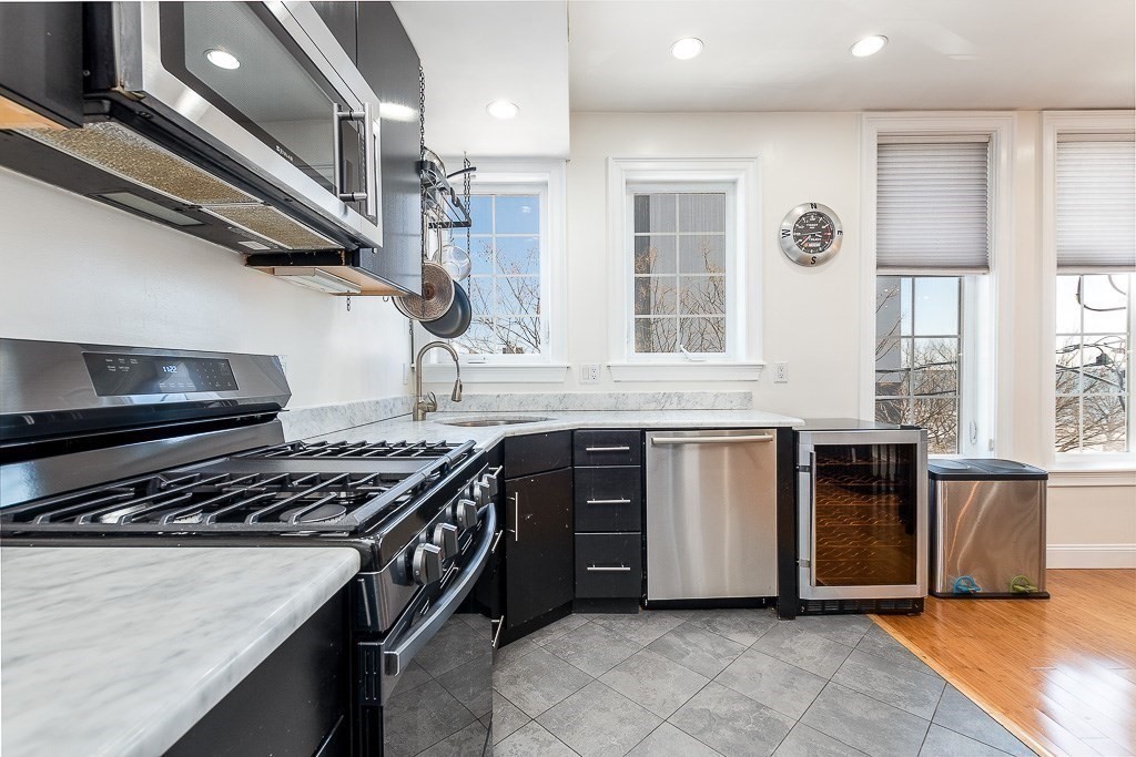 151 G Street, Unit 3 Boston, MA 02127 - Photo 18 of 33 a kitchen with stainless steel appliances granite countertop a stove and a sink