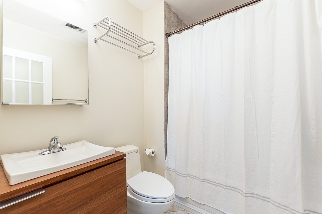 151 G Street, Unit 3 Boston, MA 02127 - Photo 21 of 33 a bathroom with a sink a toilet and shower