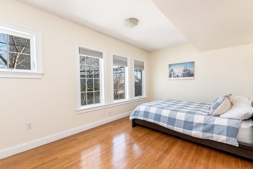 151 G Street, Unit 3 Boston, MA 02127 - Photo 27 of 33 a bedroom with a bed and wooden floor