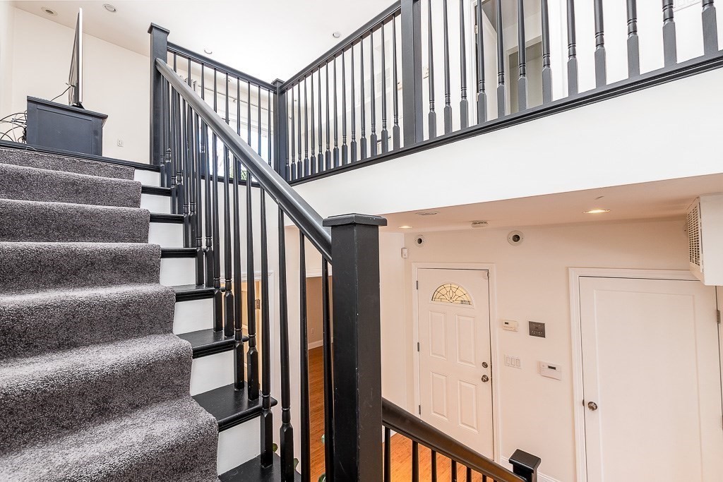 151 G Street, Unit 3 Boston, MA 02127 - Photo 31 of 33 a view of staircase with lots of frames on wall and a window