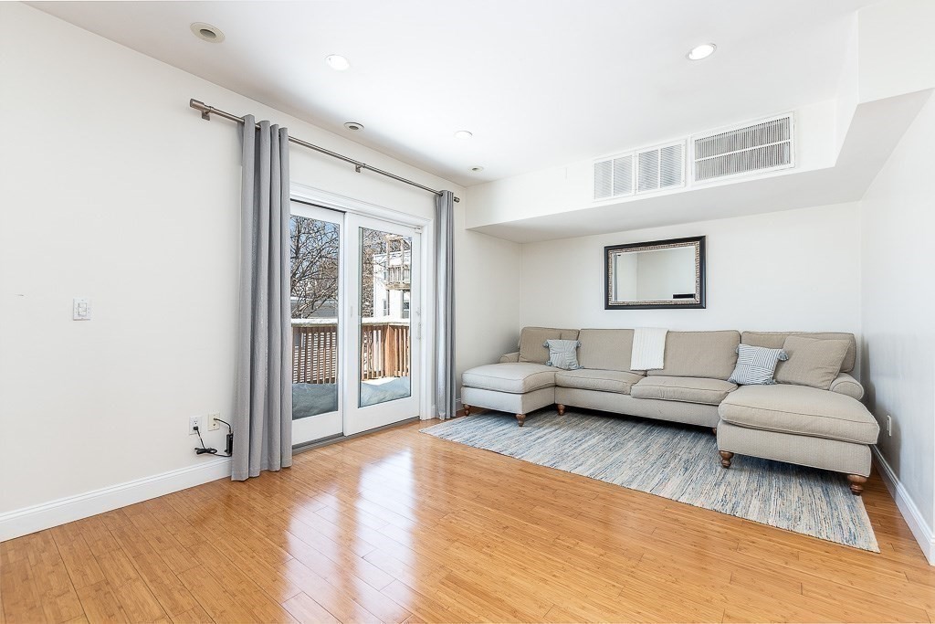 151 G Street, Unit 3 Boston, MA 02127 - Photo 7 of 33 a living room with furniture and a large window