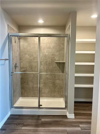 a bathroom with a glass shower door